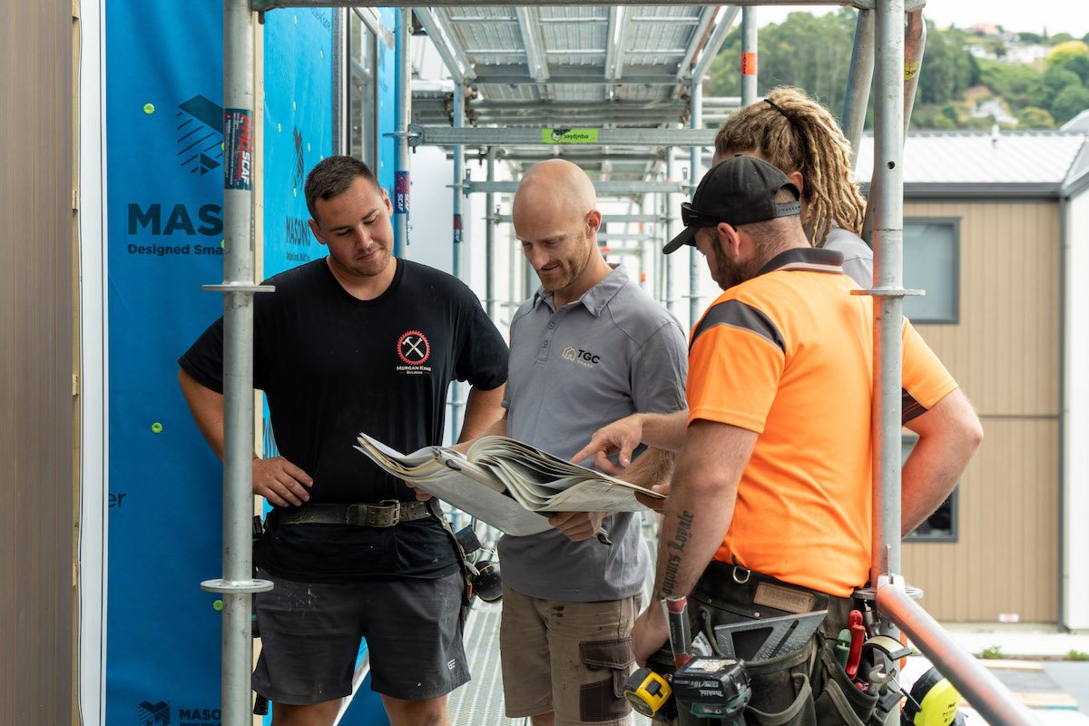 TGC Homes Director Tom with team in construction site